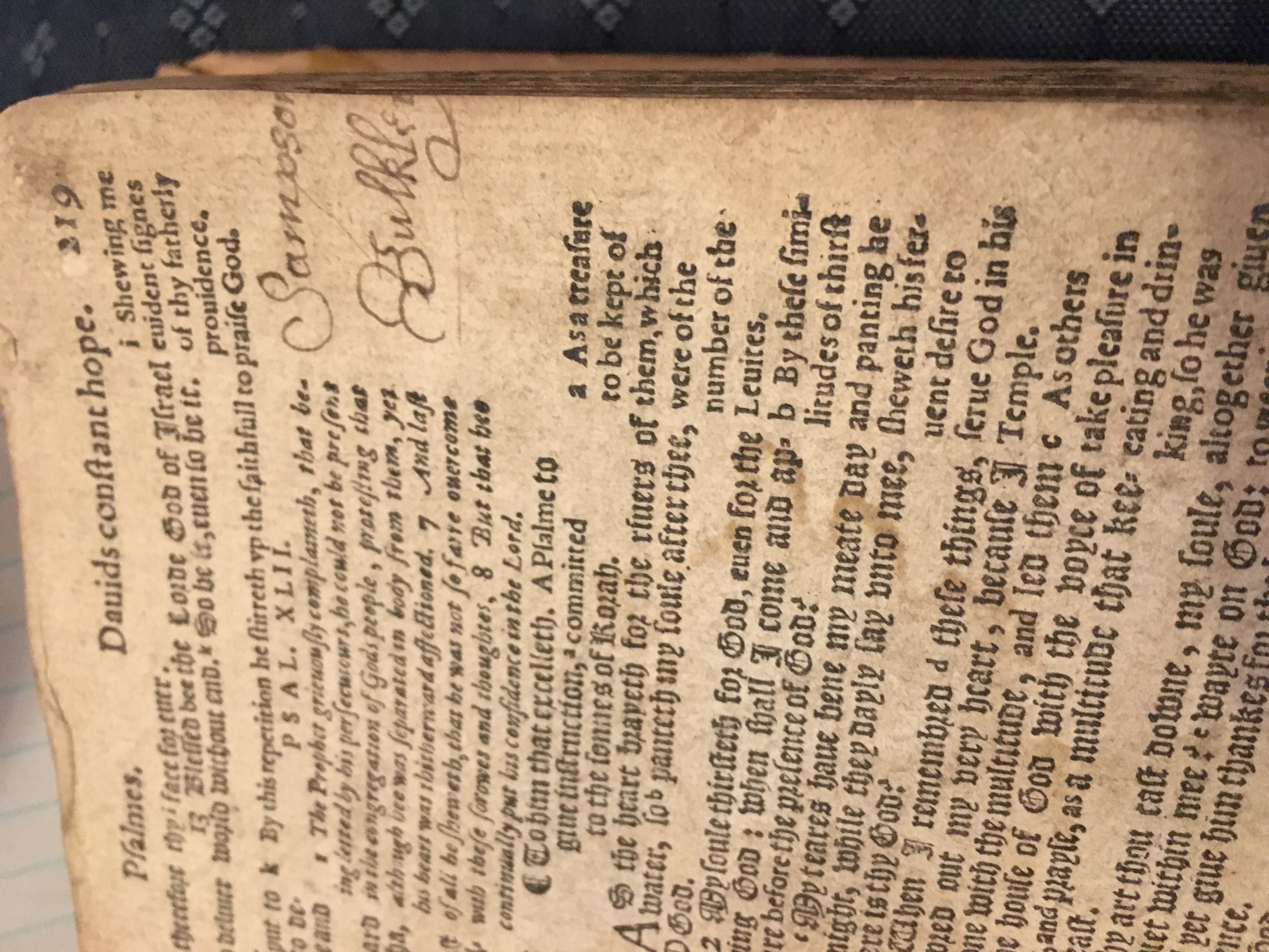A page of the Psalms in the Breeches Bible with a handwritten name in the margin